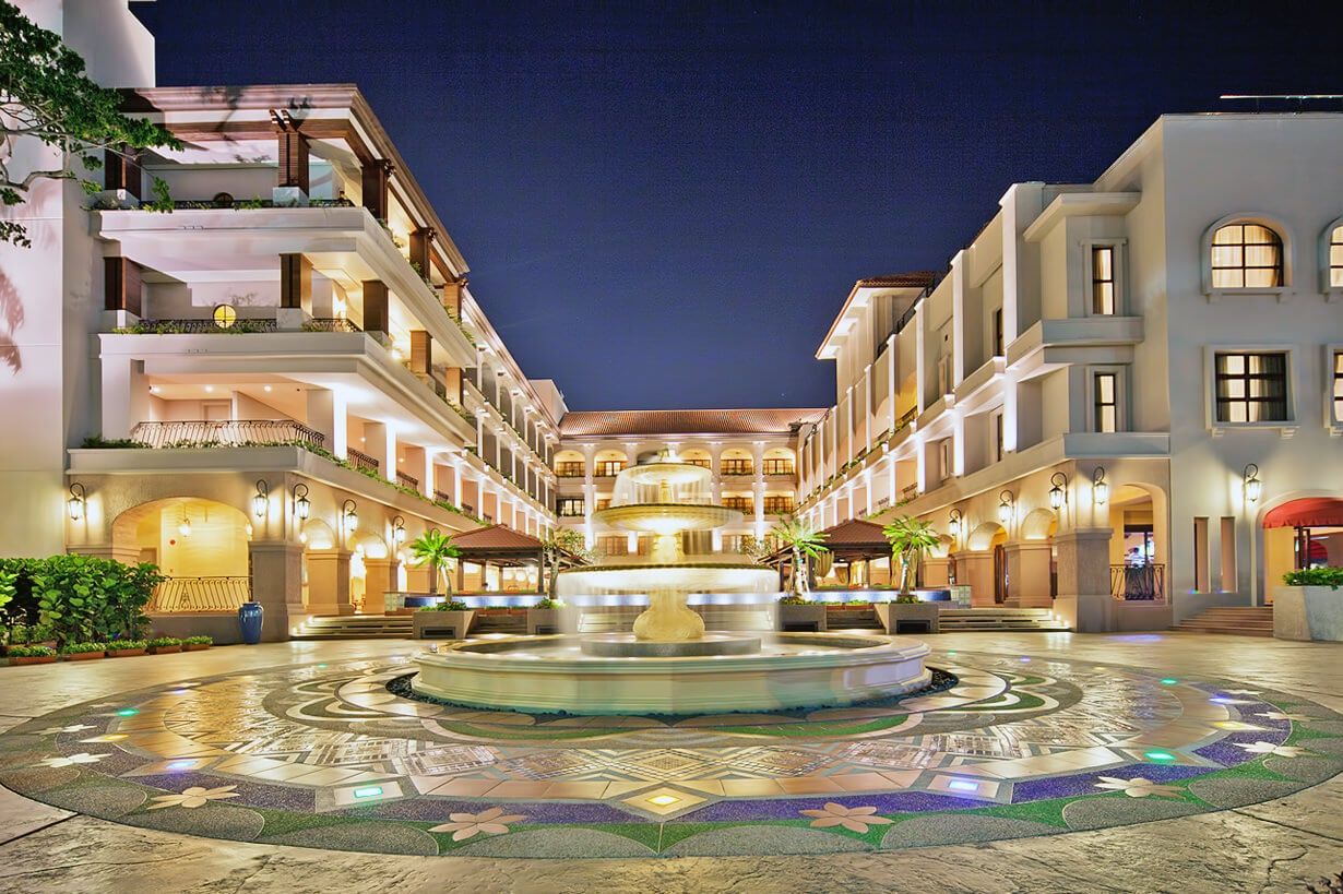 Hotel courtyard with a fountain lit at night