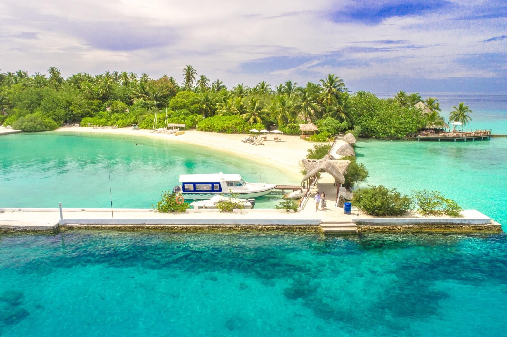Aerial view of a small tropical island with a boat dock