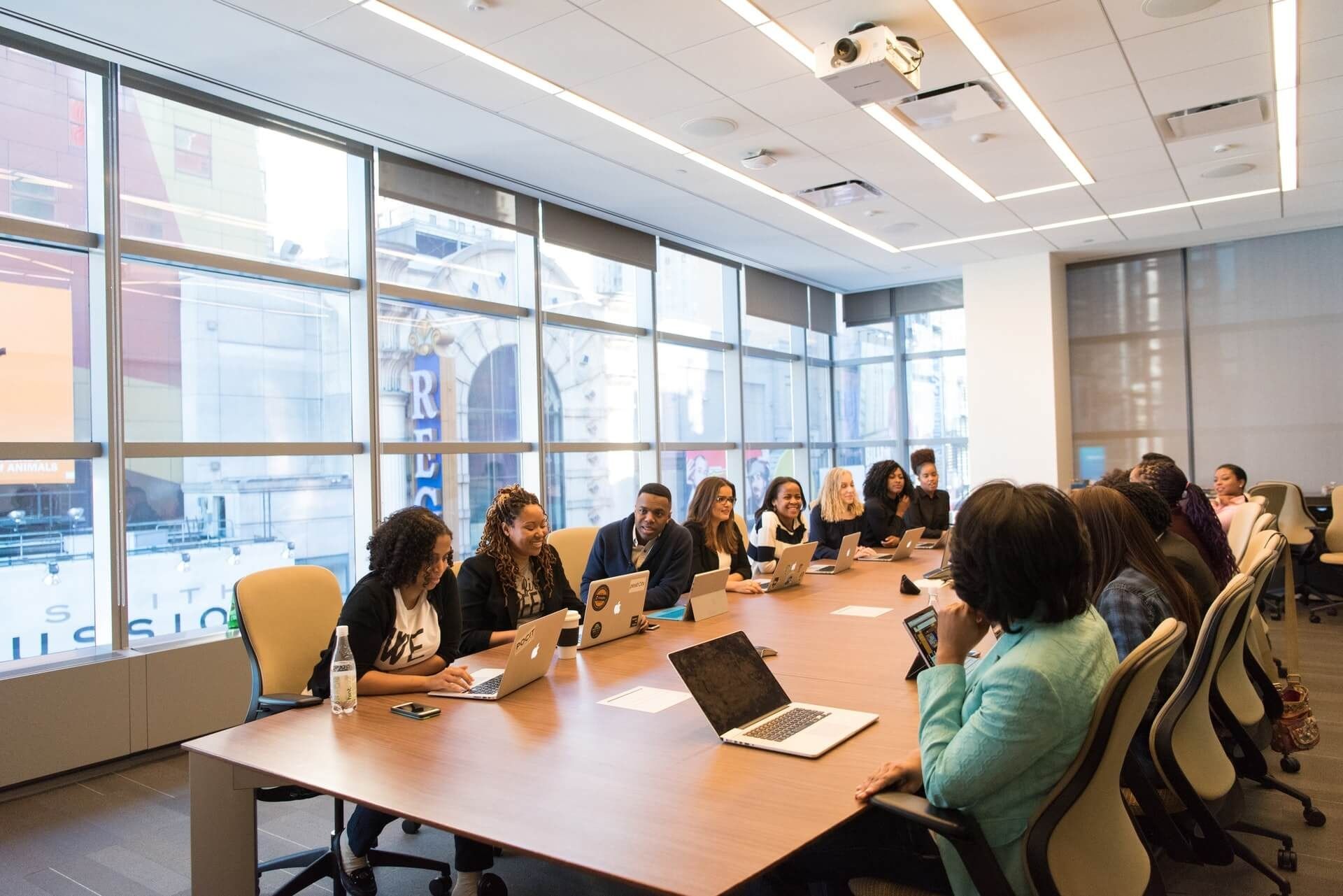 Colleagues around a long table in a bright meeting room