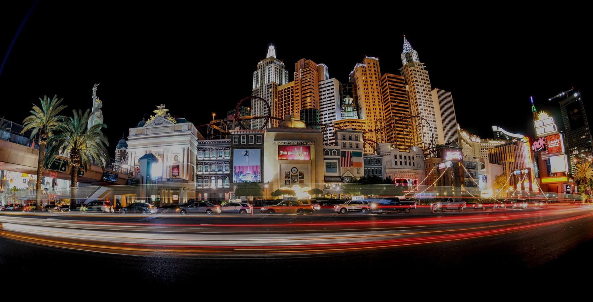 City hotels lit up at night with traffic light trails